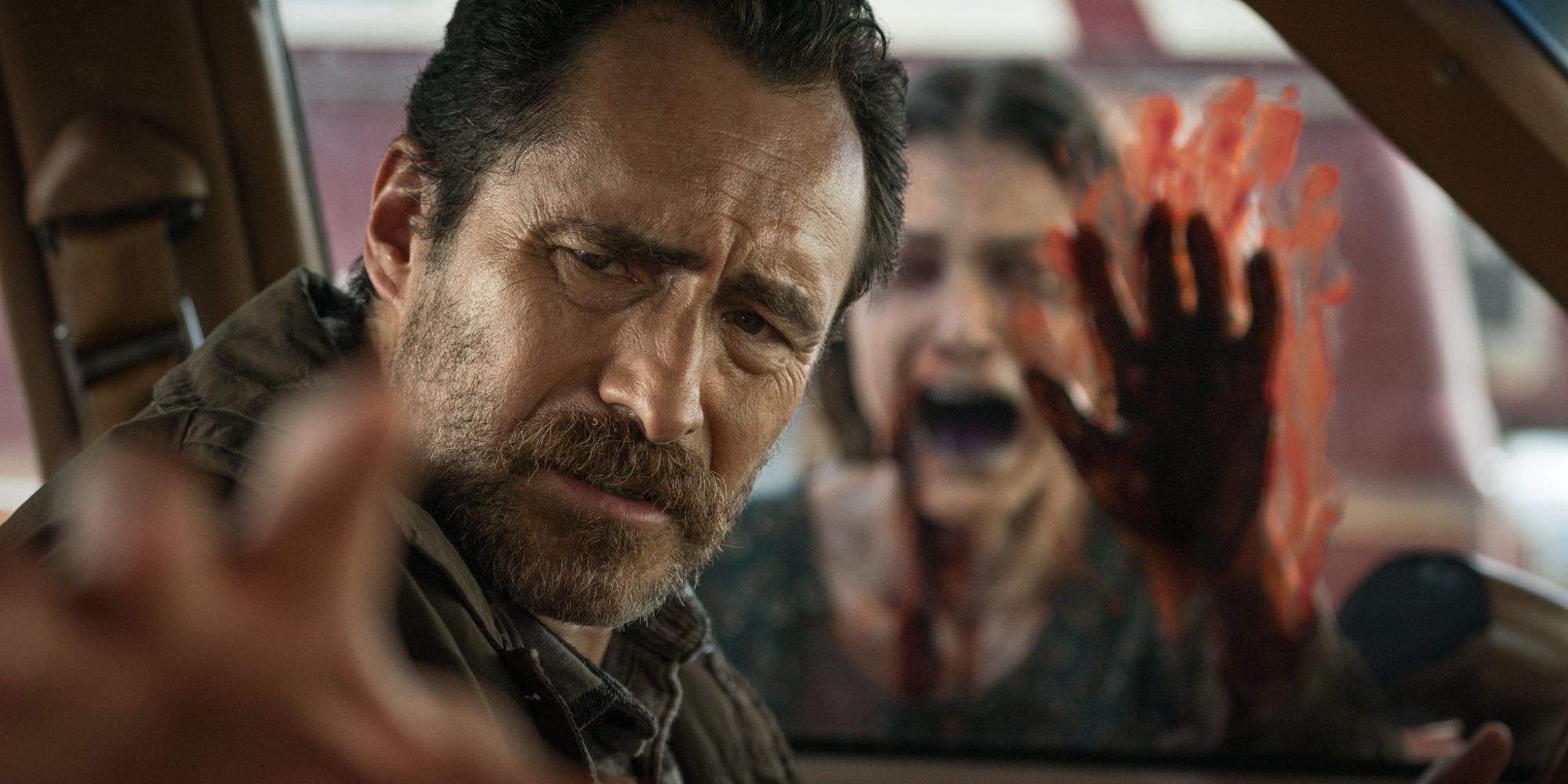 Damien Bichir in the car with a bloodied figure at the window in The Grudge (2020)