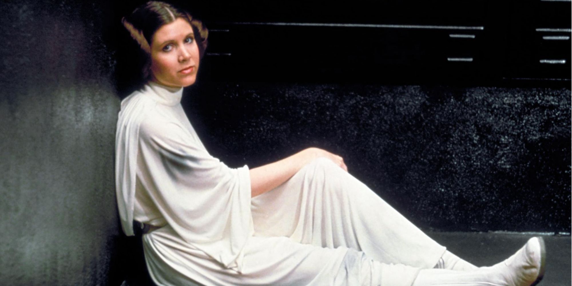 Carrie Fisher as Princess Leia waits in a prison cell in Star Wars A New Hope.