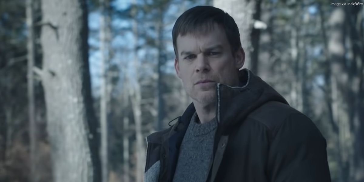 Dexter Morgan in Dexter: New Blood staring down at something while standing in the forest.