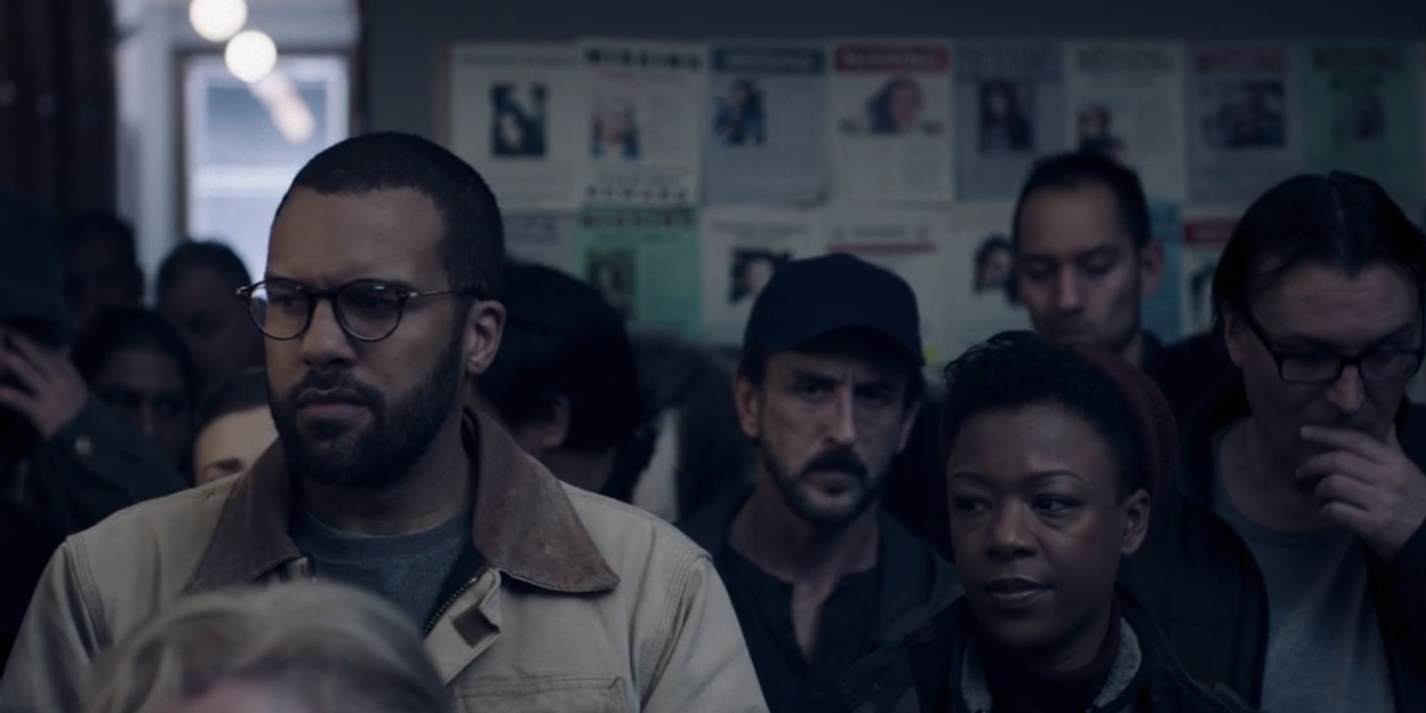 A crowd looking cautiously at missing person signs