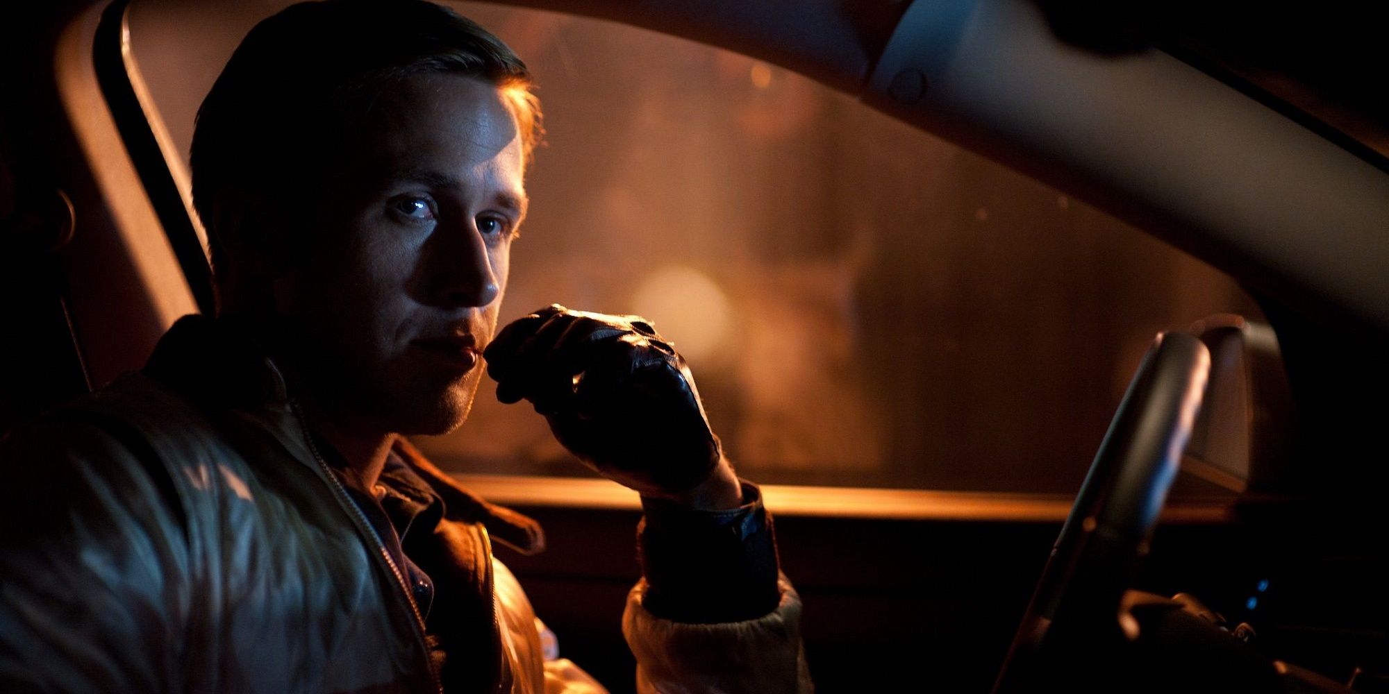 Driver in his car at night while being a getaway driver in 'Drive.'