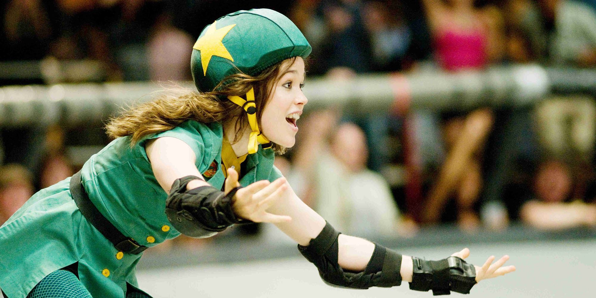 Elliot Page rollerskating with a green uniform