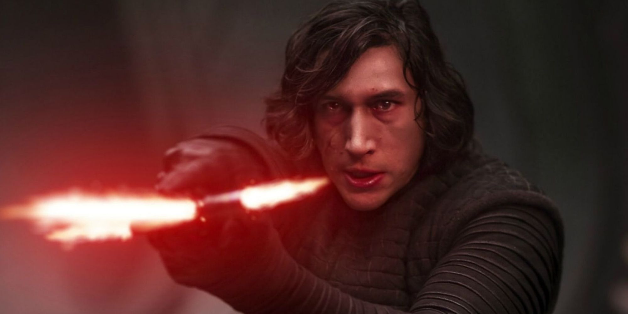 Adam Driver as Kylo Ren with red lightsaber in Star Wars: The Force Awakens