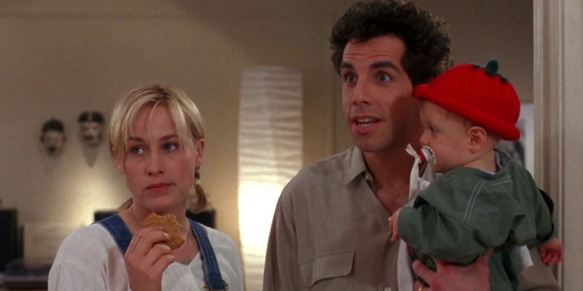 Patricia Arquette and Ben Stiller as Nancy and Mel Coplin looking ahead while carrying their small child in the film Flirting with Disaster.