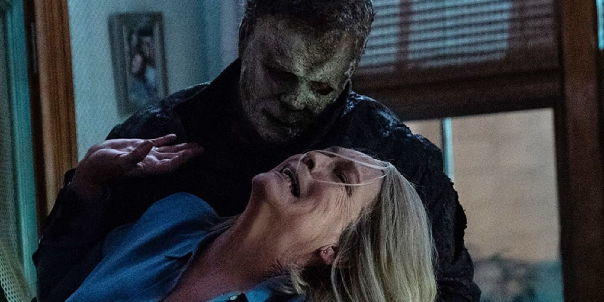 Michael Myers attacking Laurie Strode by pulling her hair back in 'Halloween Ends.'