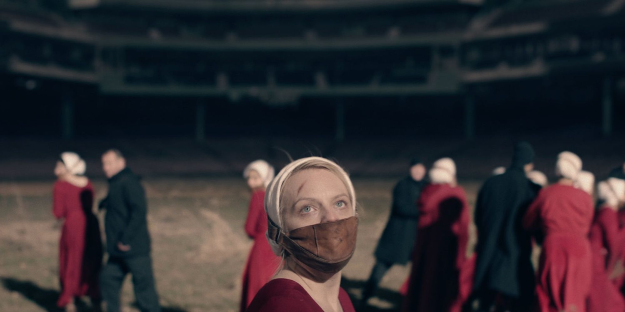 June with her face restrained, looking fearful