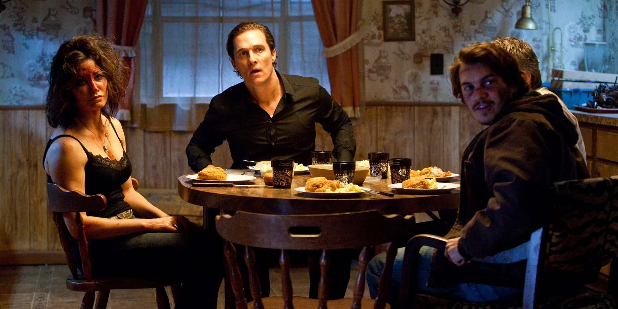 Killer Joe sitting at the table with the family in 'Killer Joe.'