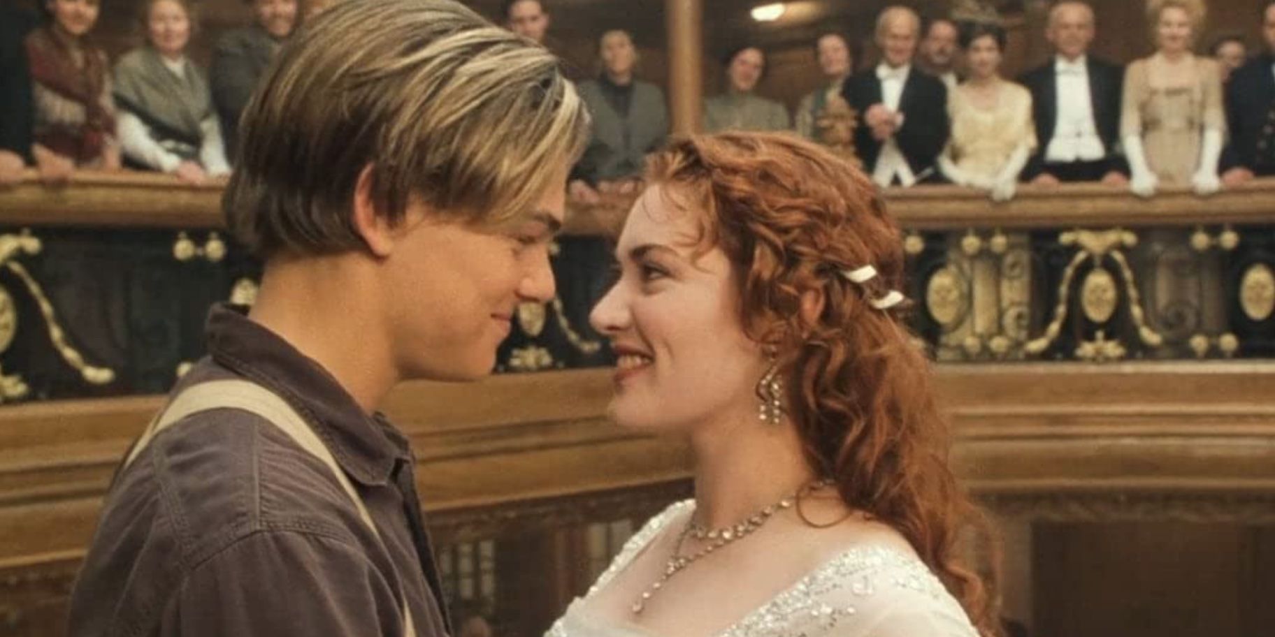 Leonardo DiCaprio as Jack looking at Kate Winslet as Rose and smiling in Titanic