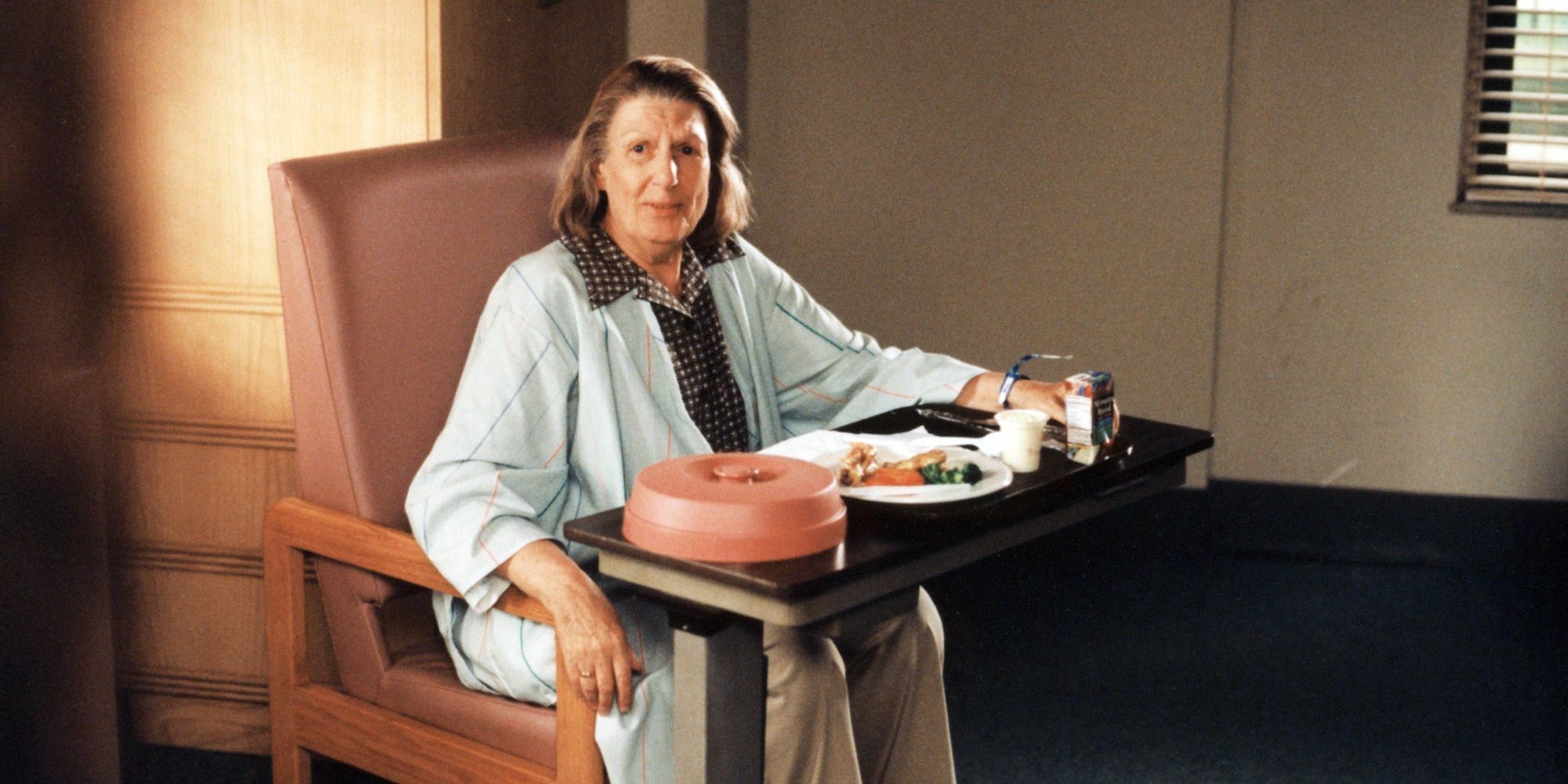 a woman sits in the chair with meal placed in front of her
