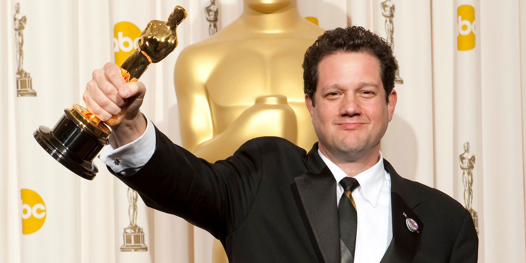 Michael Giacchino holding his Oscar at the event's backstage