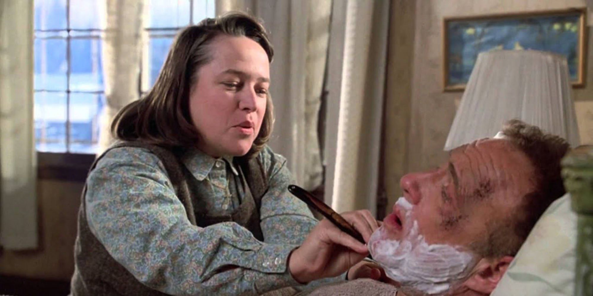 Annie helping Paul to shave his beard in Misery (1990)