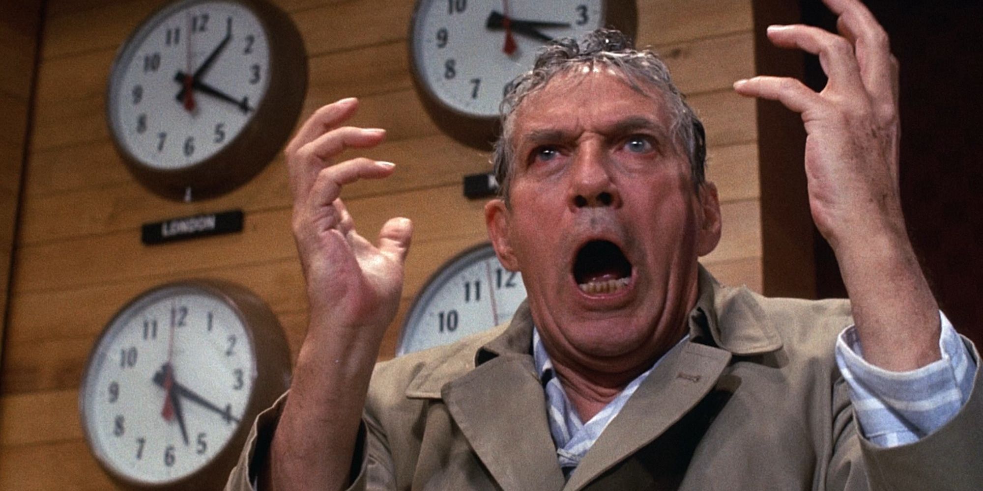 Peter Finch as Howard Beale yelling in front of clocks in Network (1976)