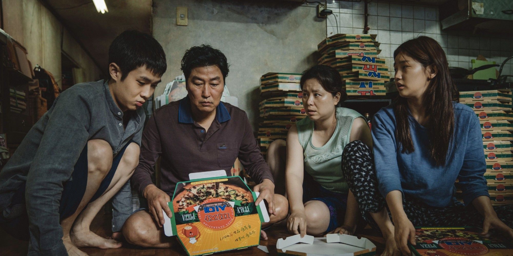 Choi Woo-shik, Song Kang-ho, Jang Hye-jin and Park So-dam as the Kim family folding pizza boxes in 'Parasite' in 'Parasite'