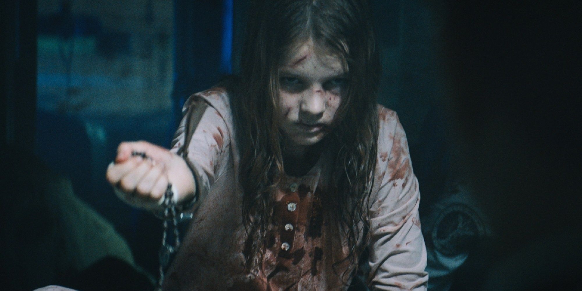A little girl bloodied and bruised carrying a rosary in 'Prey for the Devil.'