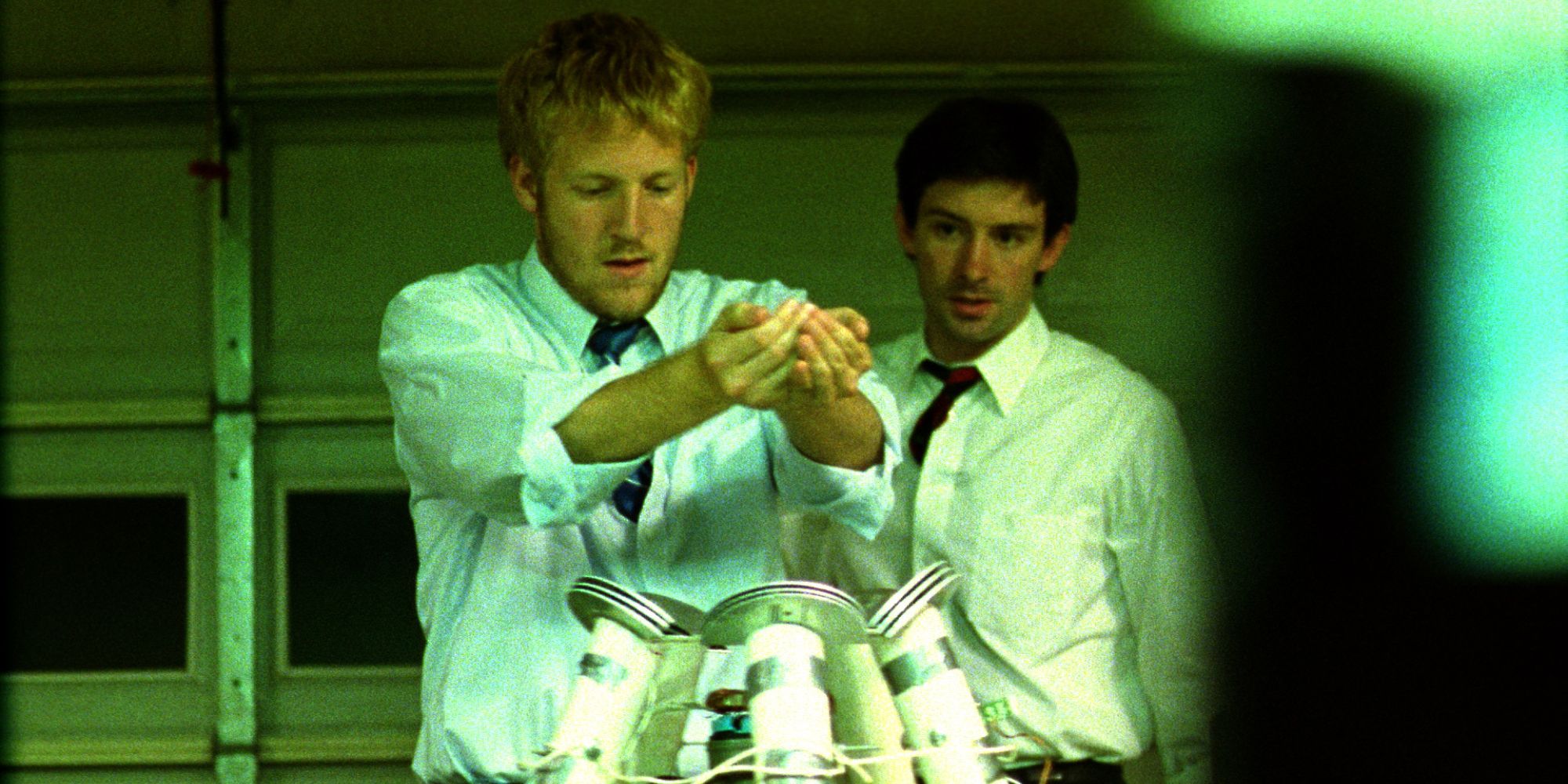 Two men looking at a machine in Primer