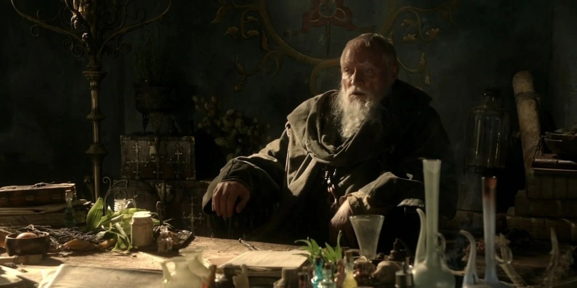 Grand Maester Pycelle sitting in a lab in Game of Thrones