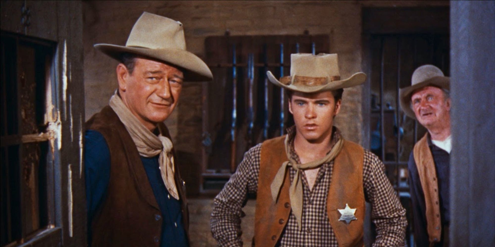 John Wayne as Sheriff John T. Chance and Ricky Nelson as Colorado Ryan standing in a jail in Rio Bravo