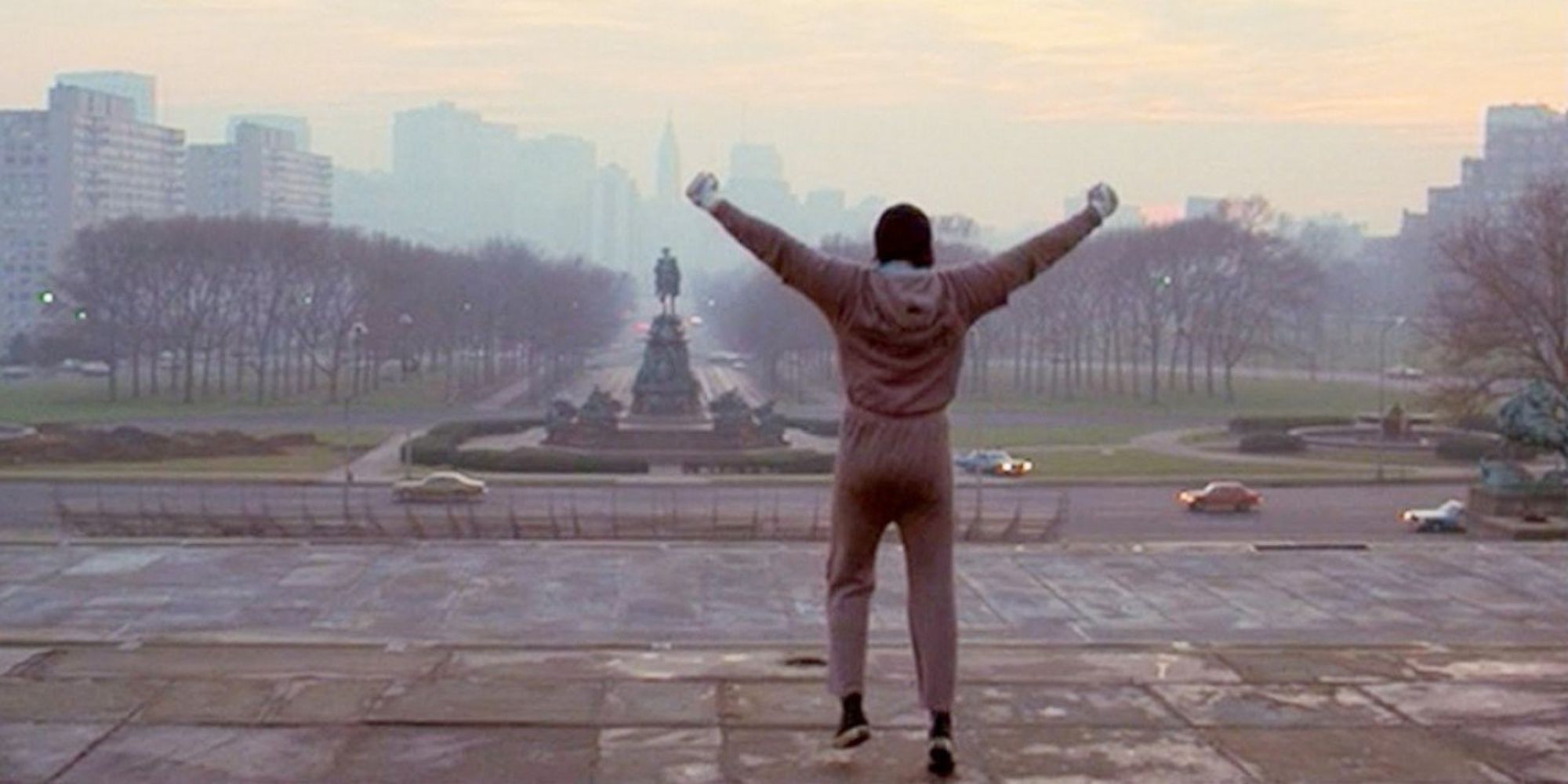 Sylvester Stallone as Rocky at the end of the workout montage with is arms raised in Rocky Balboa