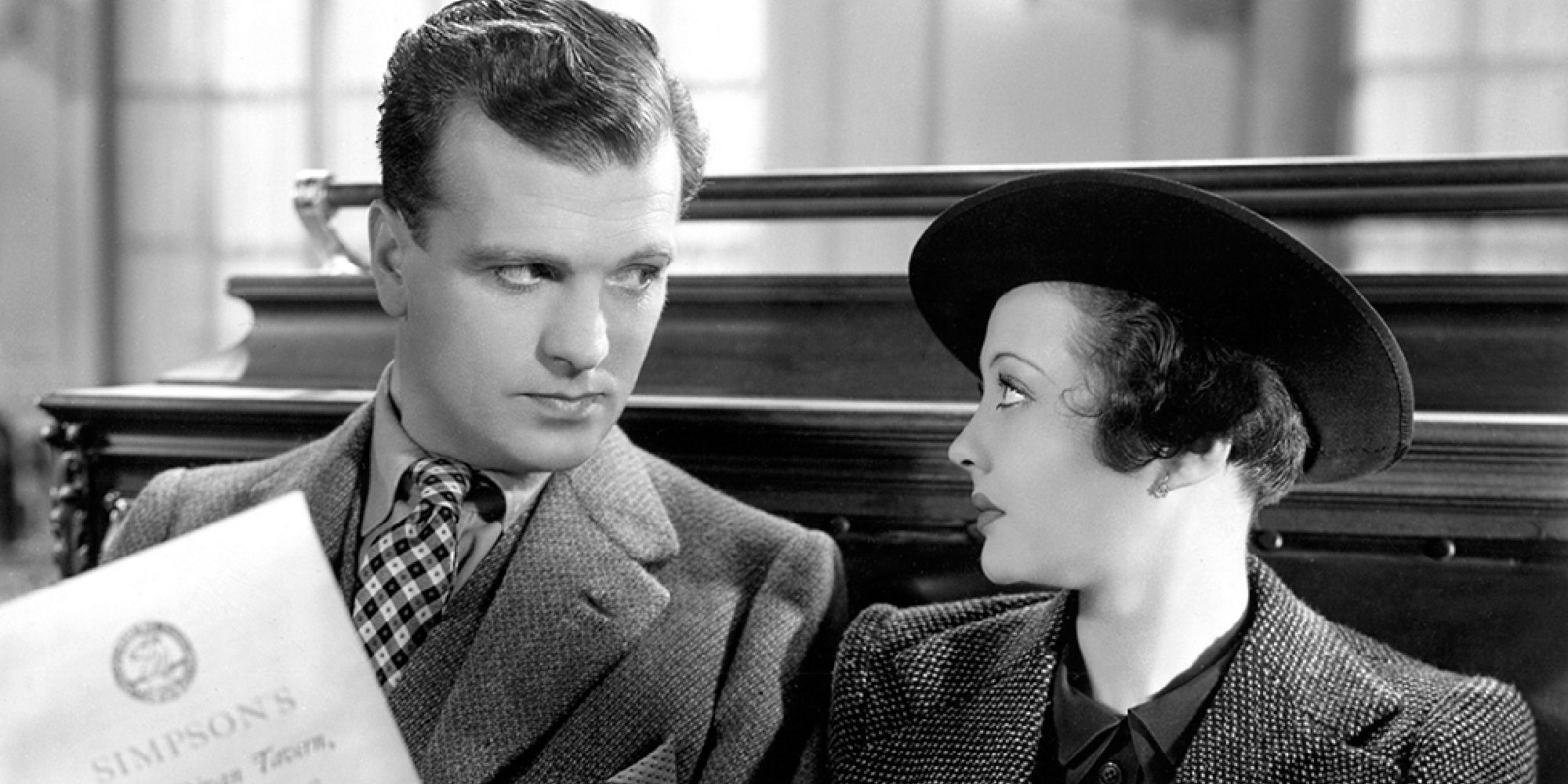 John Loader as Detective Sergeant Ted Spencer and Sylvia Sidney as Mrs Verloc sitting together in Hitchcock's Sabotage