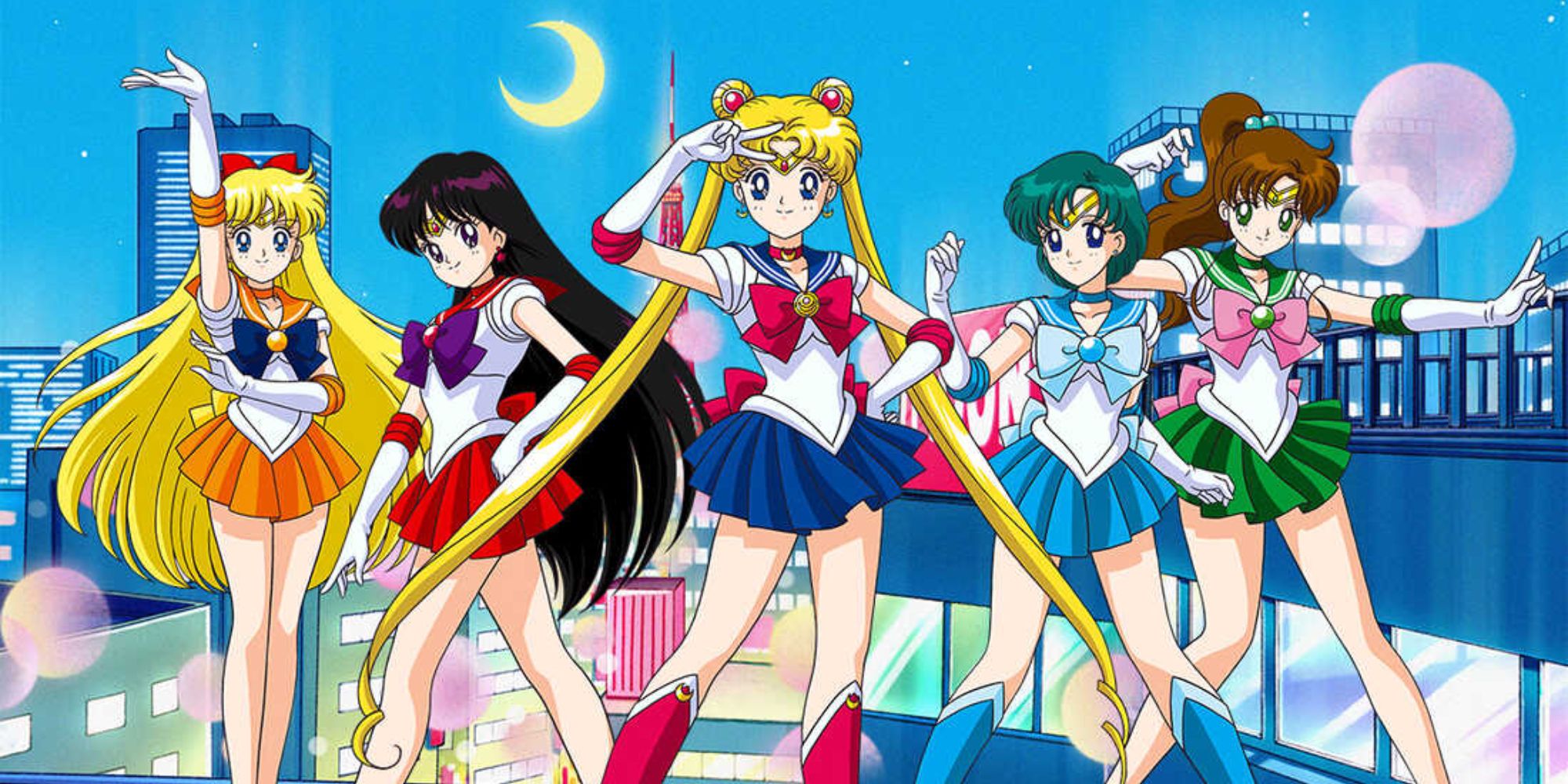 Cast of Sailor Moon posing on a building at night
