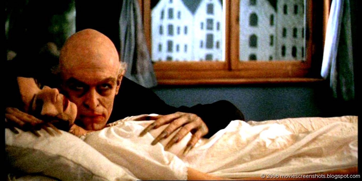 Max Schrek as Nosferatu creeping on a woman lying in bed in the movie Shadow of the Vampire (2000)