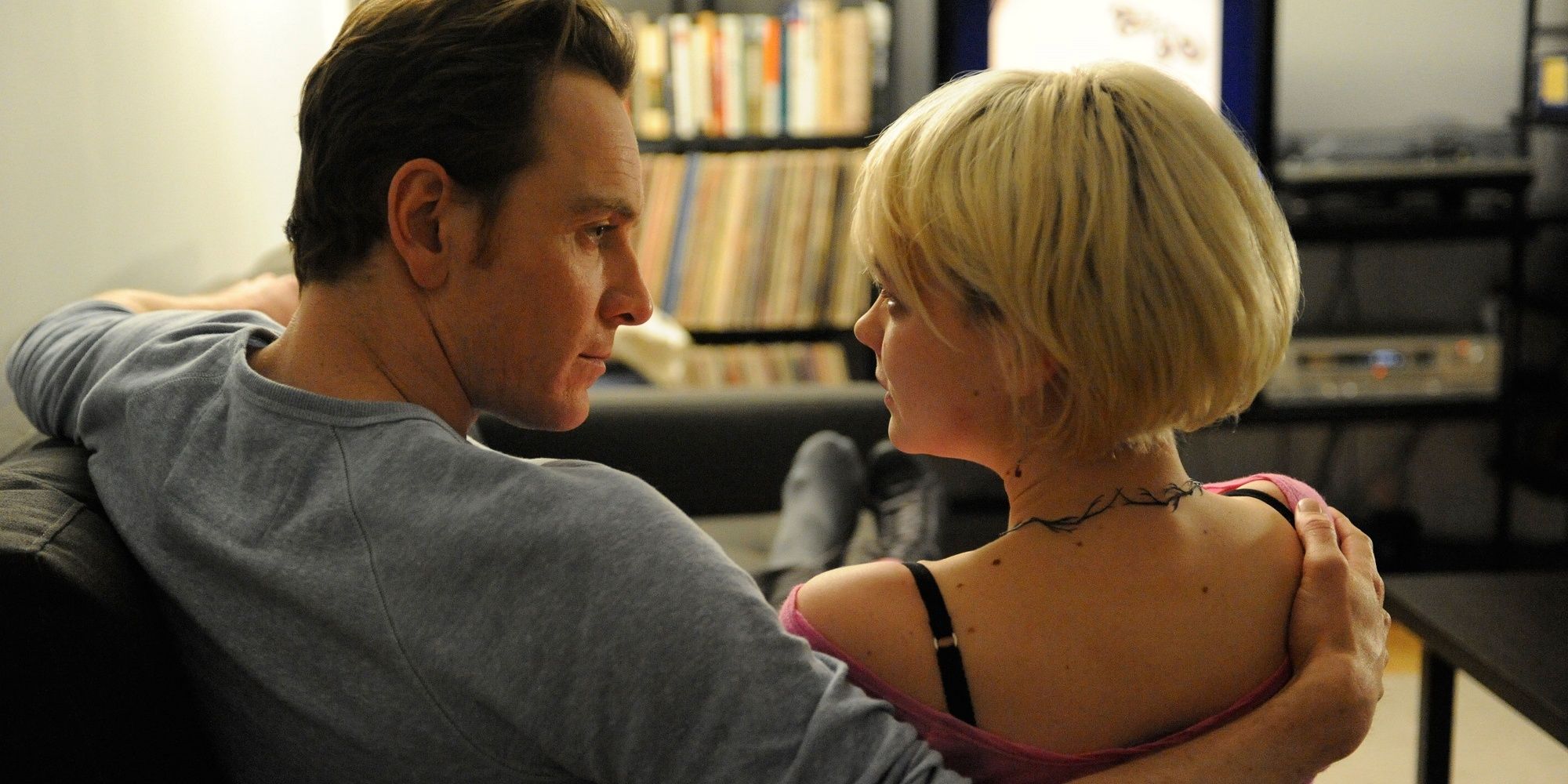 Michael Fassbender and Carey Mulligan sitting together on a couch in 'Shame.'