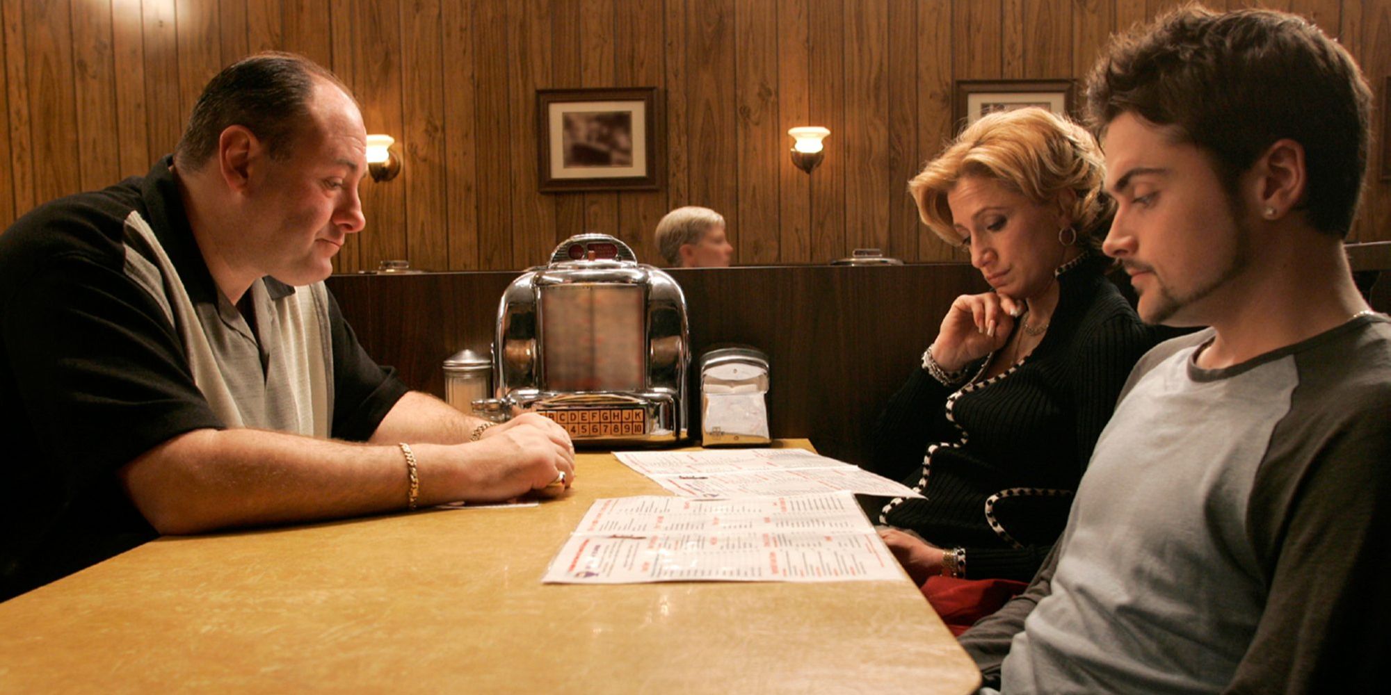 James Gandolfini sitting across from Edie Falco and Rober Iler in The Sopranos - Made in America