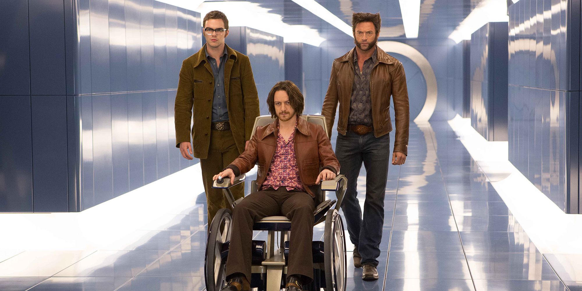Charles Xavier (James McAvoy), Beast (Nicholas Hoult), and Wolverine (Hugh Jackman) coming down a hallway, looking serious in X Men: Days of Future Past