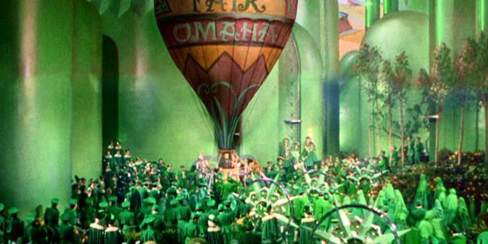 Oz prepares to take off in his hot air balloon in front of the denizens of the Emerald City