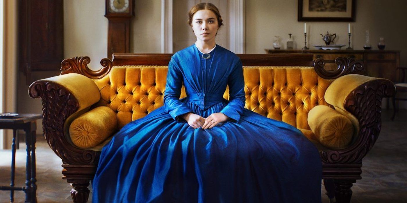 Florence Pugh as Katherine Lester sitting on a couch and looking at the camera in Lady Macbeth