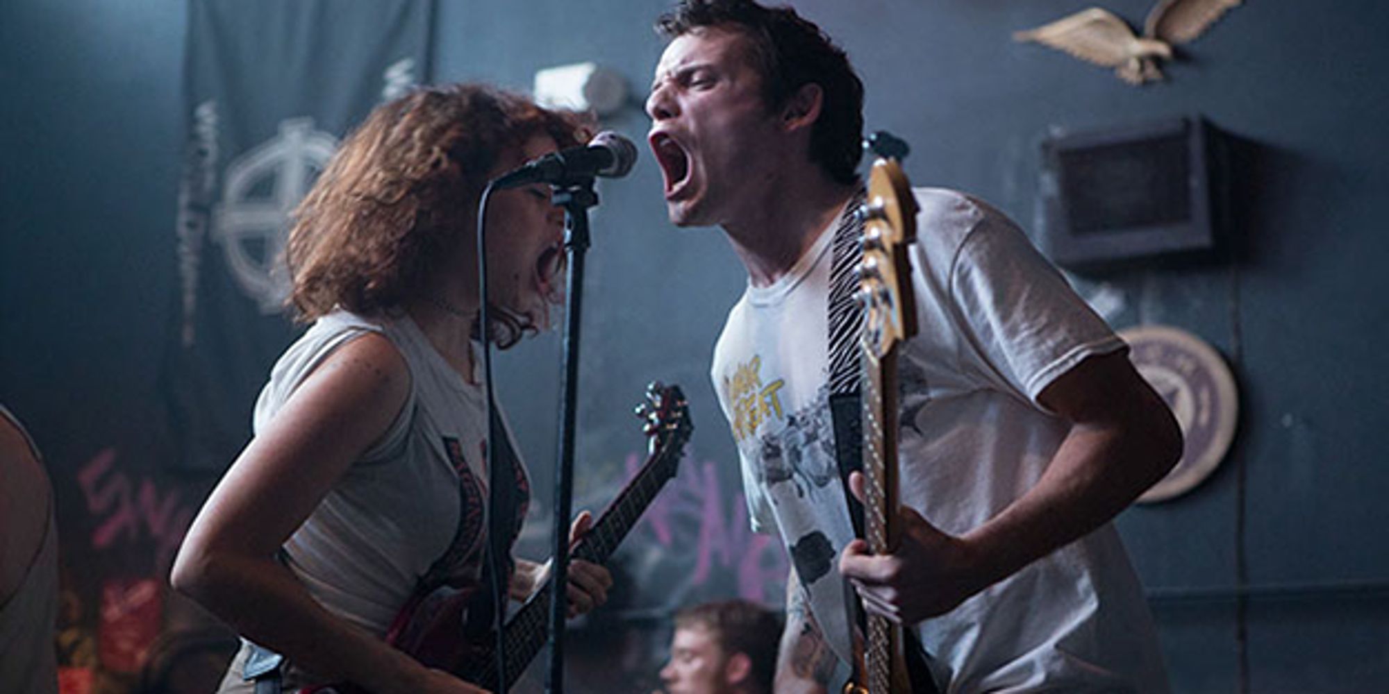 Alia Shawkat and Anton Yelchin perform as part of their punk band in the film Green Room