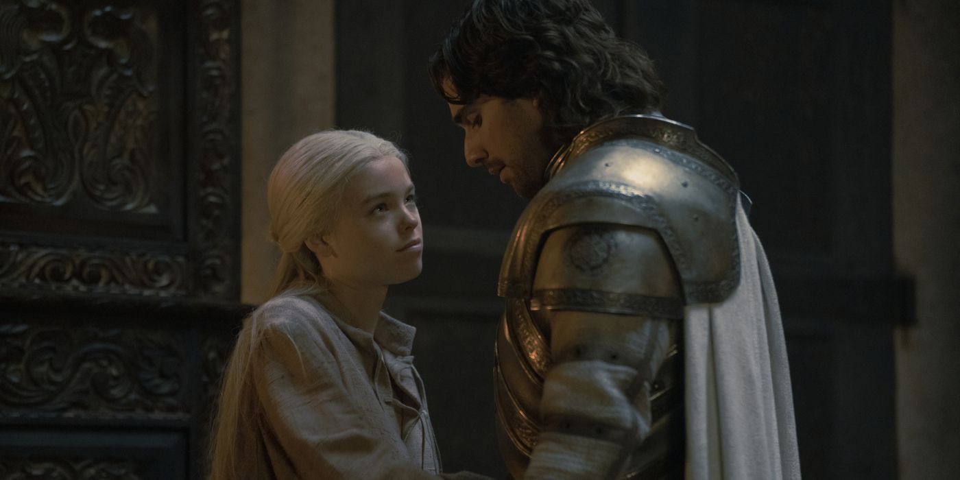 Milly Alcock as Rhaenyra Targaryen looking up at Fabien Frankel as Criston Cole in his armor