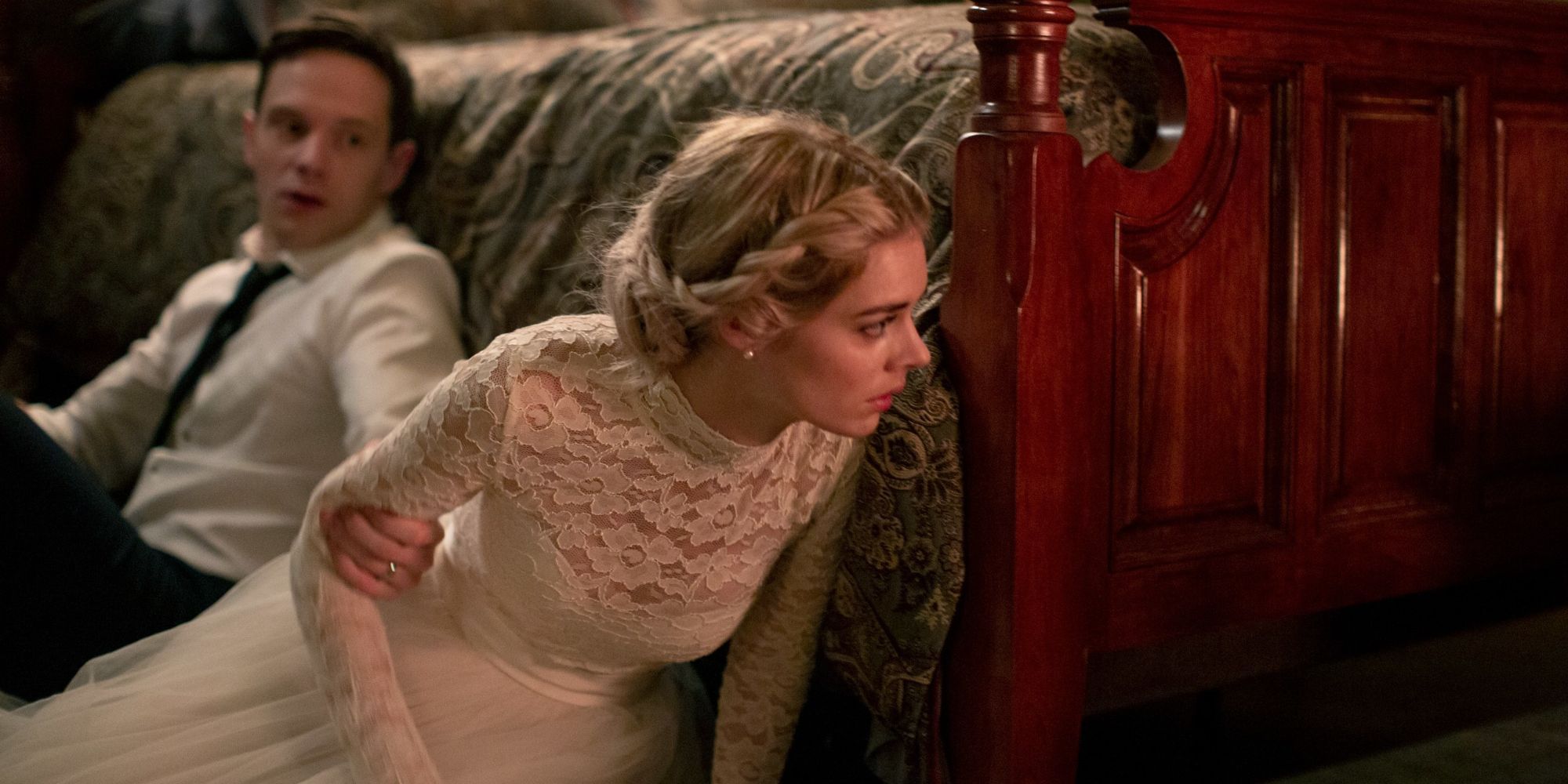 Still from 'Ready or Not': The Bride And Groom Hide Behind The Bed 