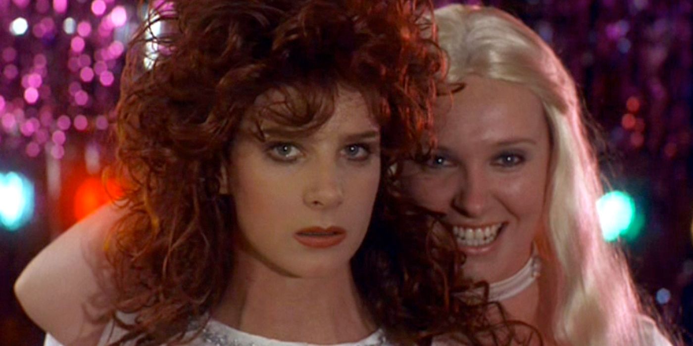 Rachel Griffiths and Toni Collette stand on stage in wigs in this still from Muriel's Wedding