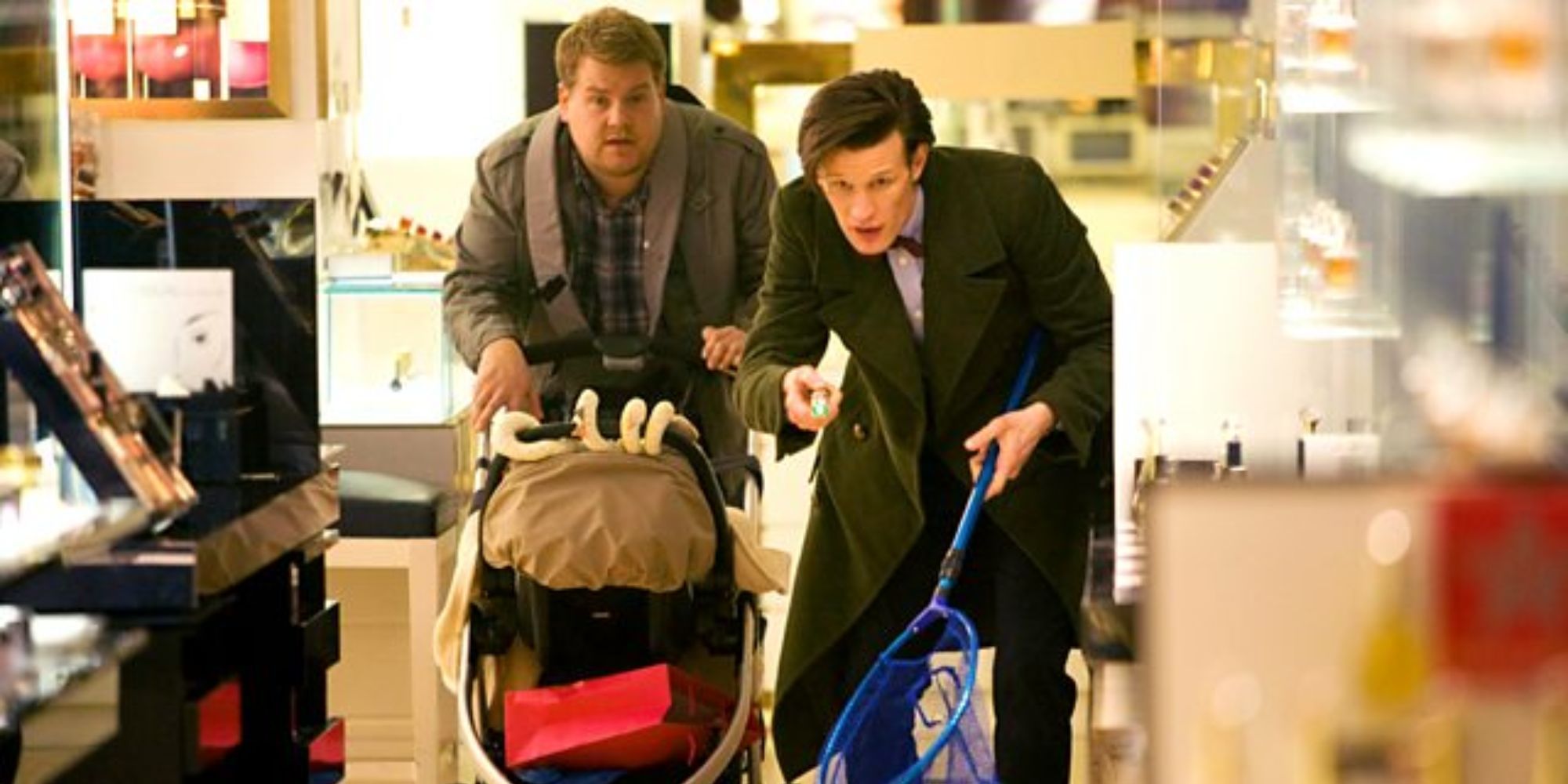 Two guys pushing a baby trolly in the mall