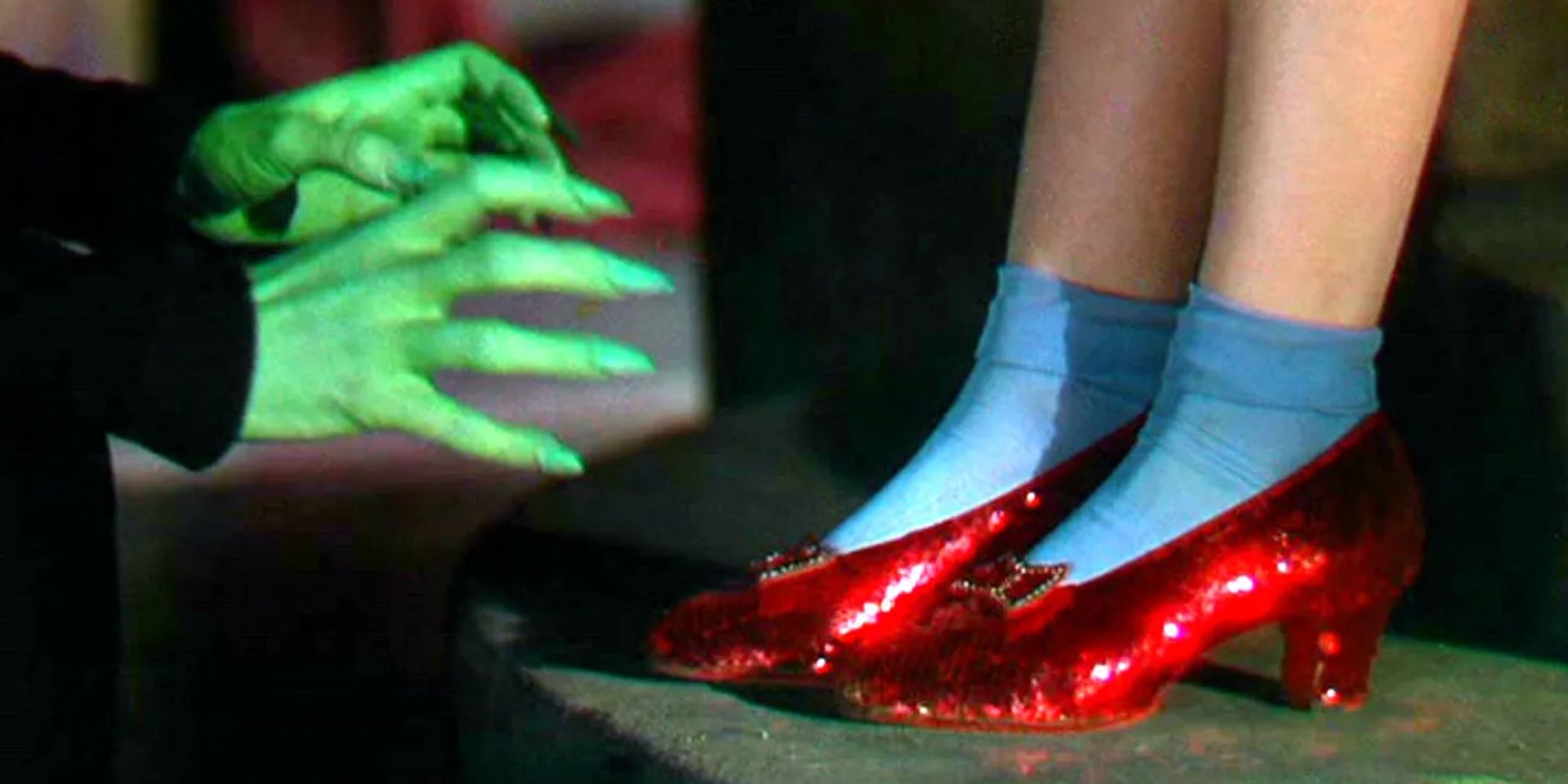 The Wicked Witch of the West reaches greedily for the ruby slippers