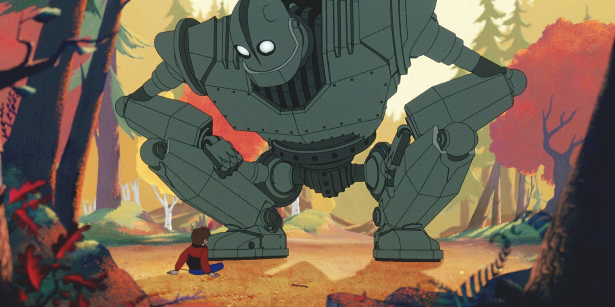 a giant robot looks down at a young boy