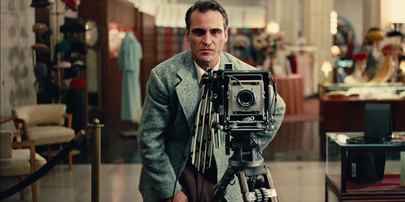 Freddie Quell preparing to take a picture at his job