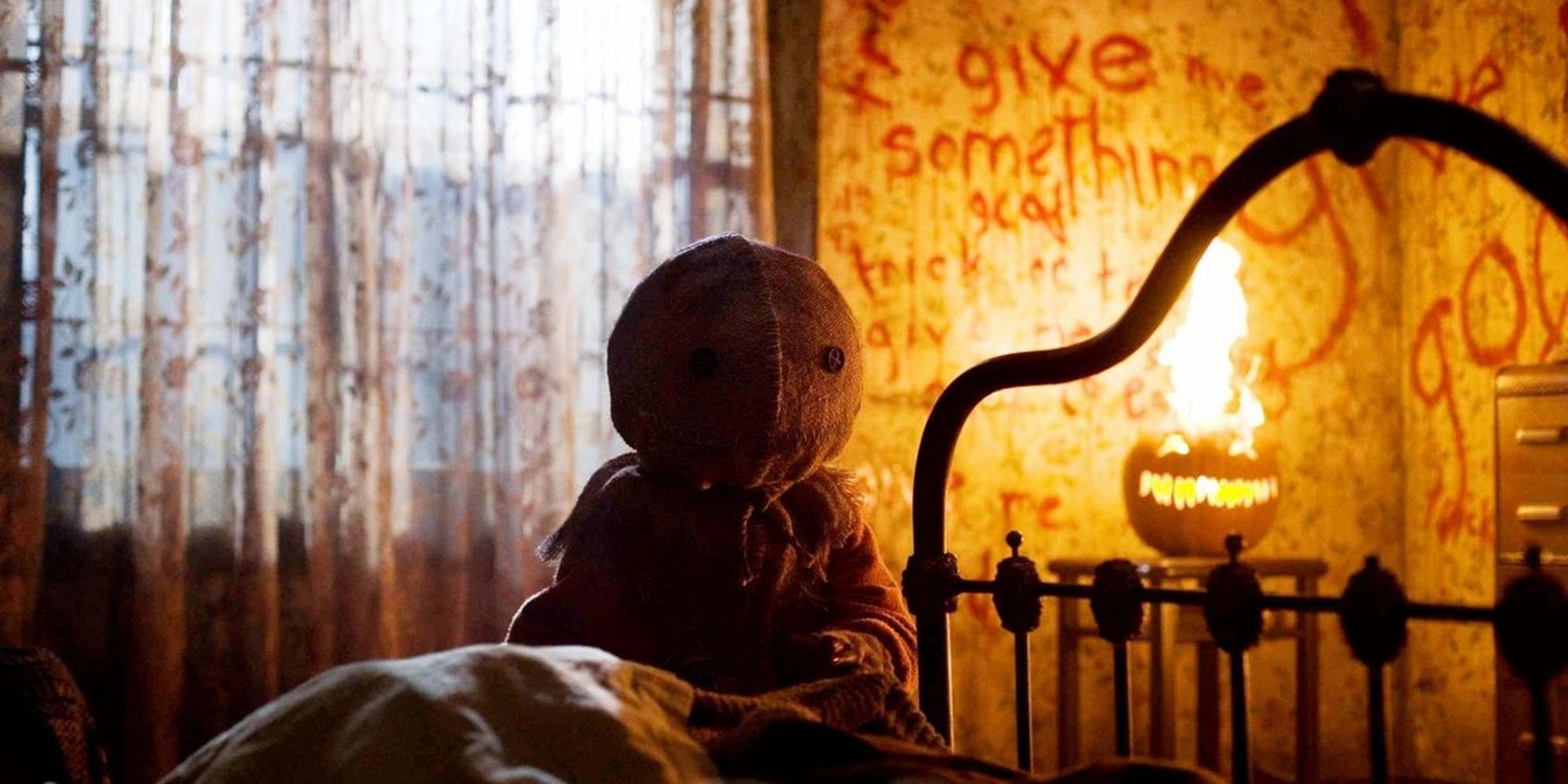 Sam, a child with a burlap sack over his head in a spooky room from Trick r Treat.