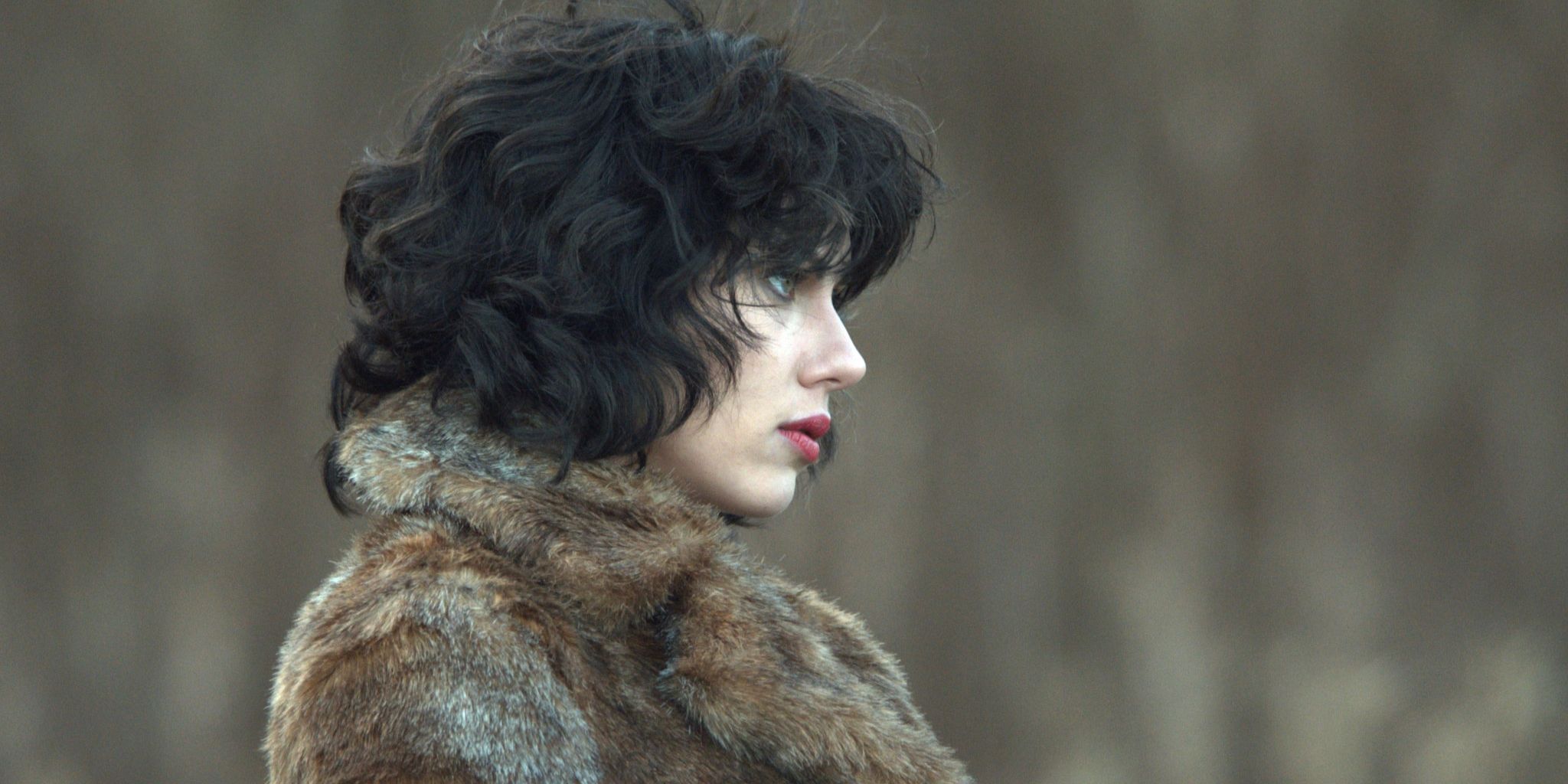 Still from 'Under the Skin': Scarlett Johansson faces to the right, wearing a fur coat.