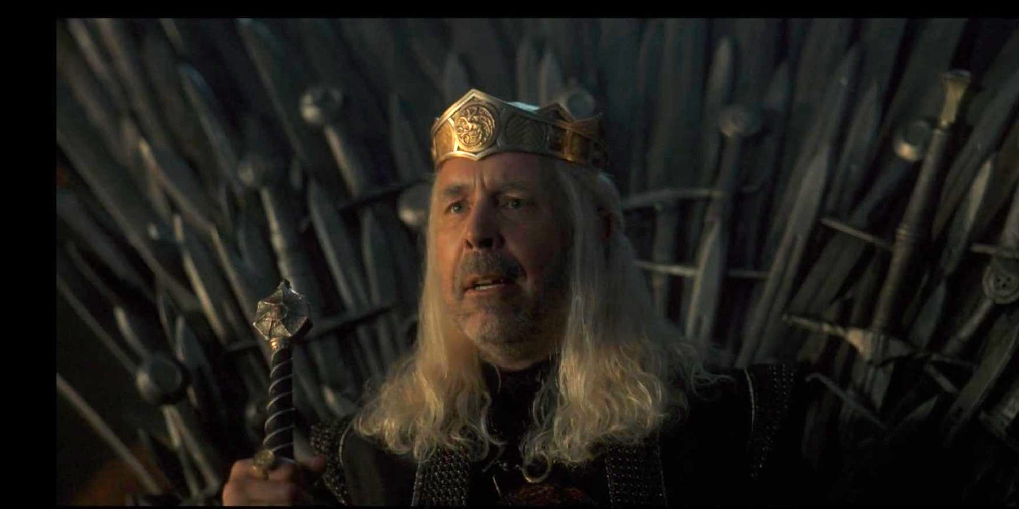 A king sits on the throne with his sword