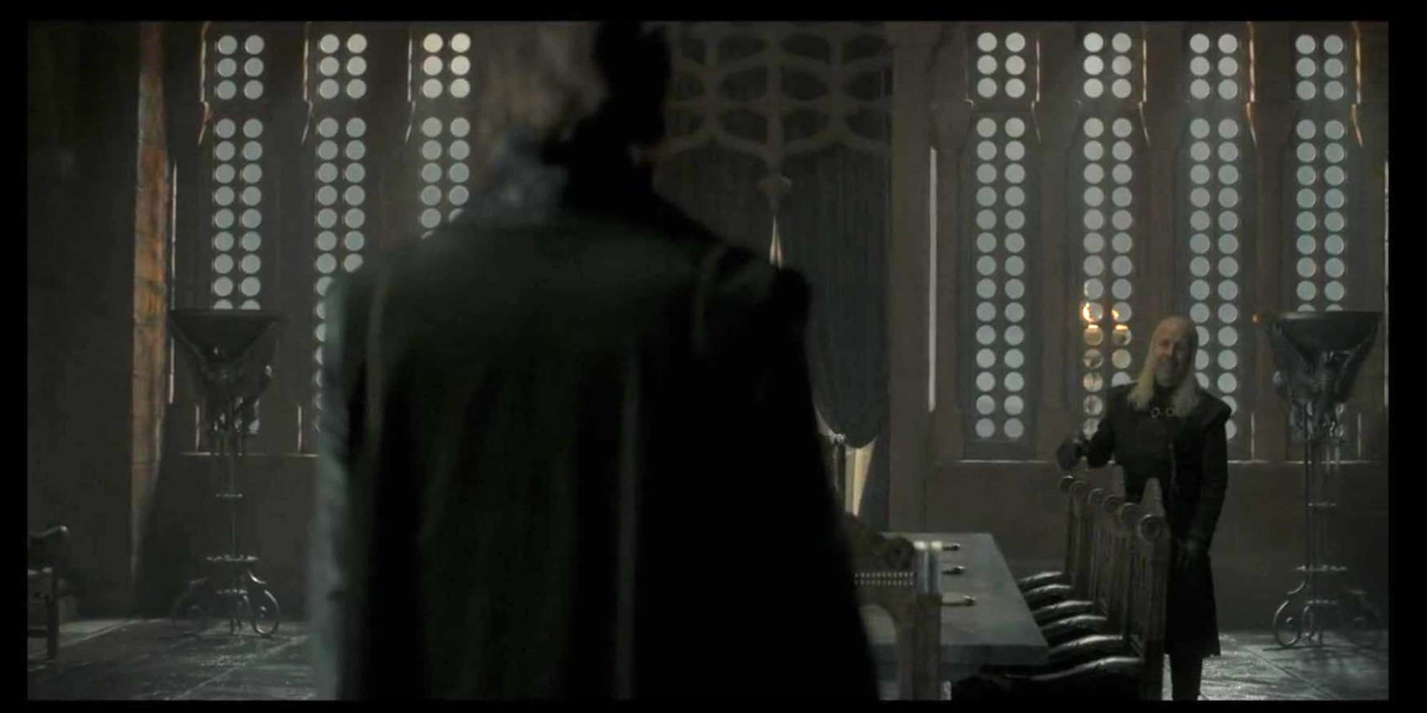 a man standing at the end and one at the other end of the room
