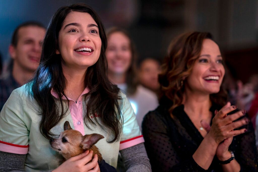 Auliʻi Cravalho as Amber Appleton and Ty Judy Reyes as Donna smiling and clapping in All Together Now