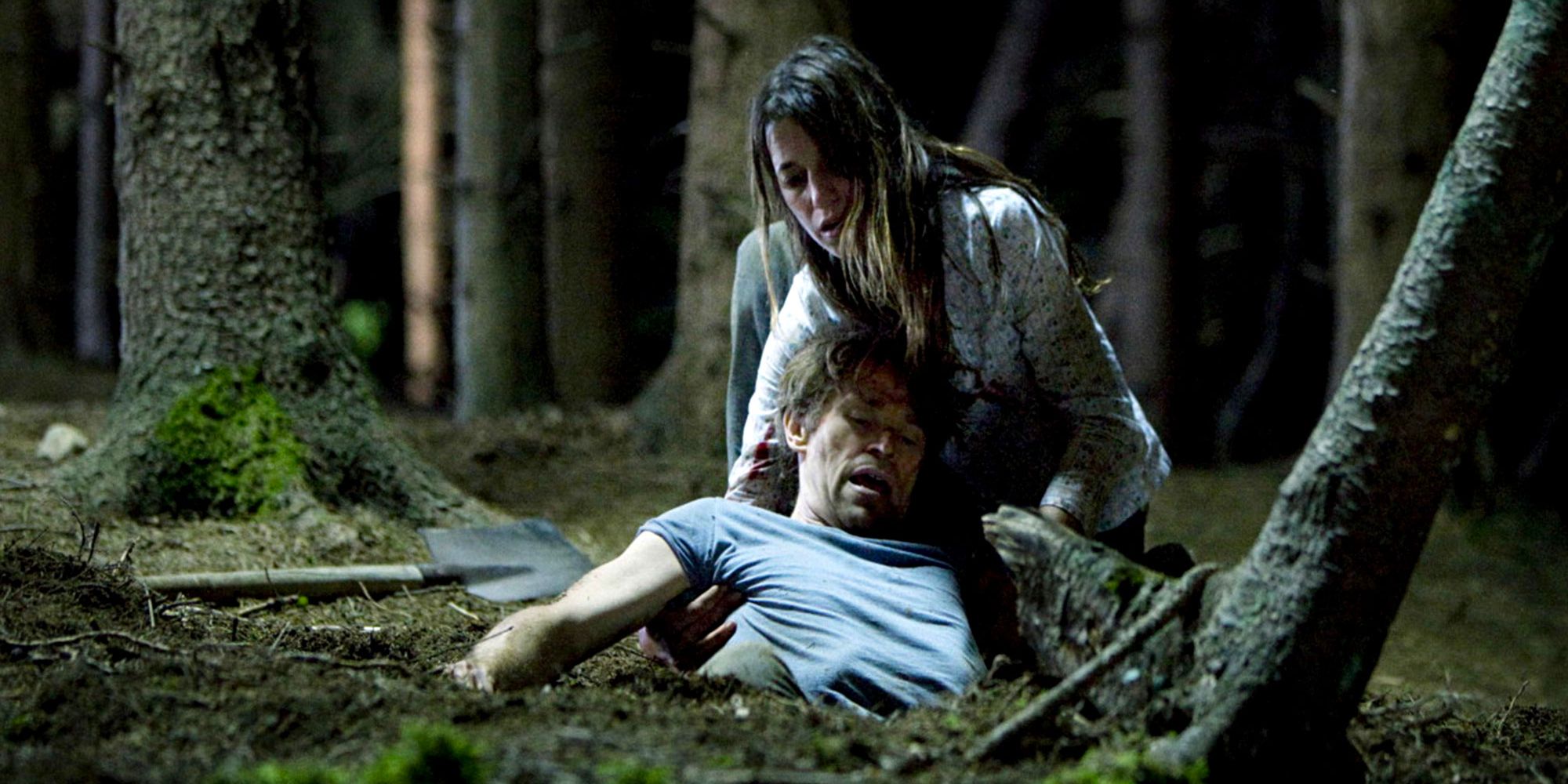 Still from 'Antichrist': The protagonist (Charlotte Gainsbourg) pulling her husband (Willem Dafoe) through the woods.