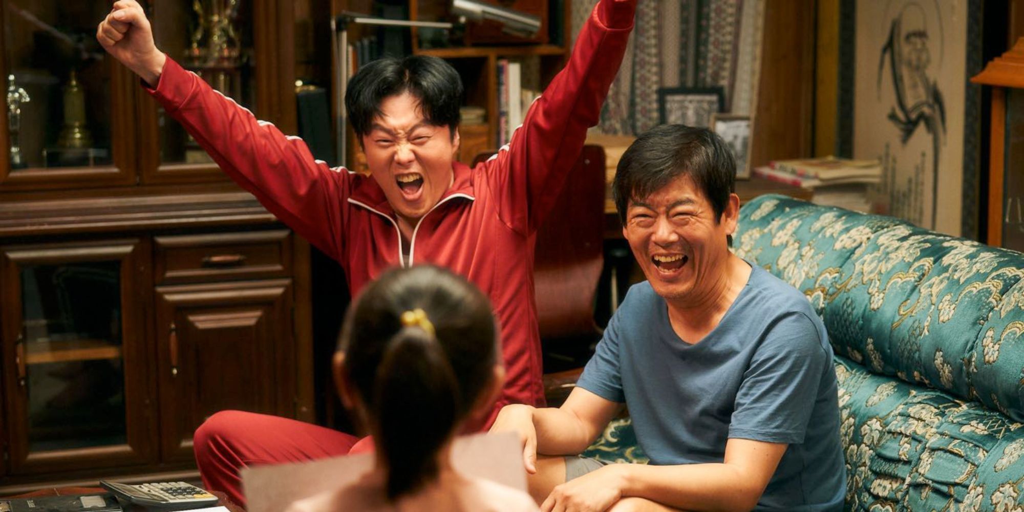 Two men cheering at a girl who is holding a piece of paper in Pawn.