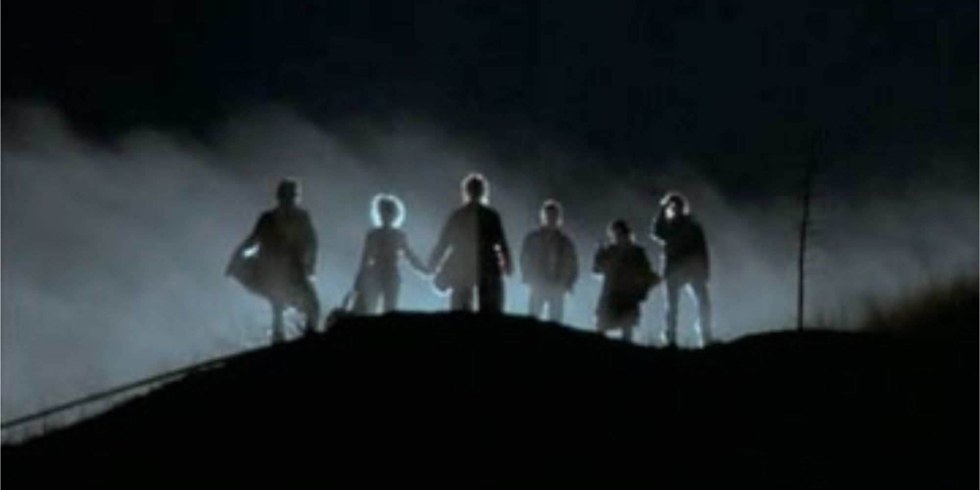 A group of vampires standing on a hill