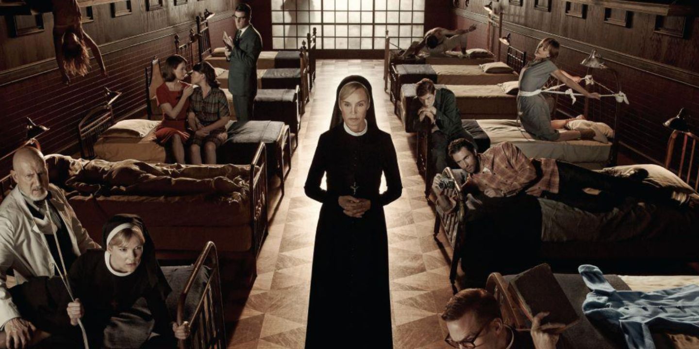 Asylum Sister Jude and the cast shown in beds with each character's backstory alluded to. 