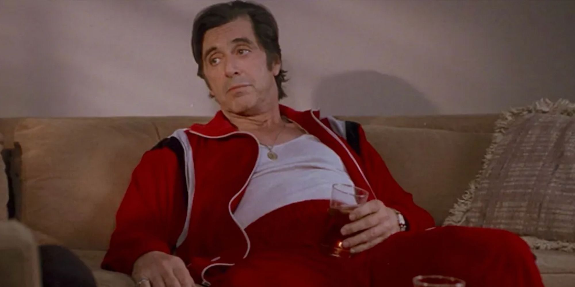 Al Pacino as Lefty in a tracksuit drinking on the couch in Donnie Brasco