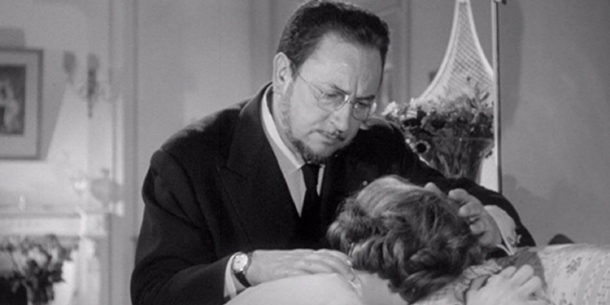 Dr. Genessier consoling his family in 'Eyes Without a Face.'