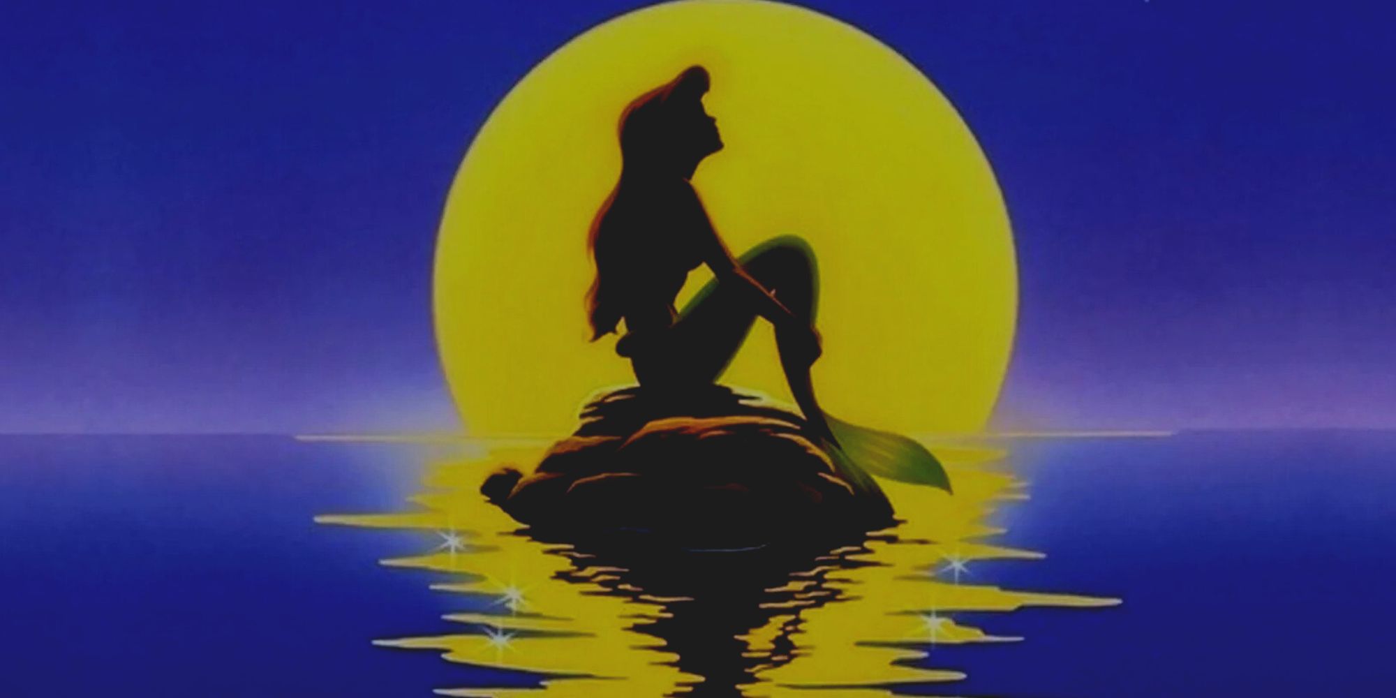 A silhouette of Ariel sitting on a rock in 1989's The Little Mermaid